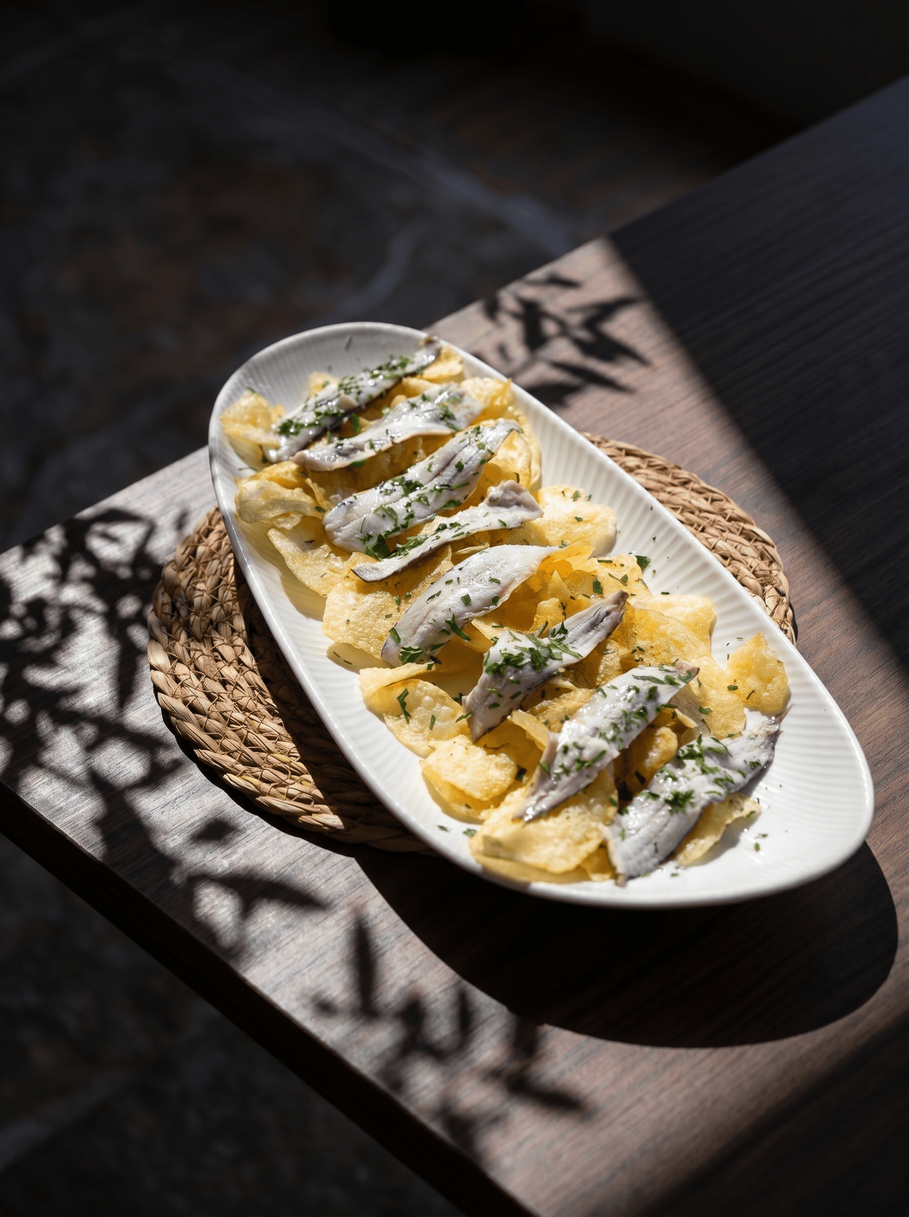 Marinated anchovies over homemade potato crisps · Acontramar, La Herradura